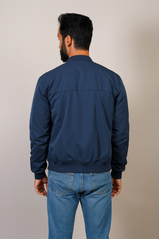 Back view of The Terminal List Chris Pratt blue bomber jacket with ribbed hem.