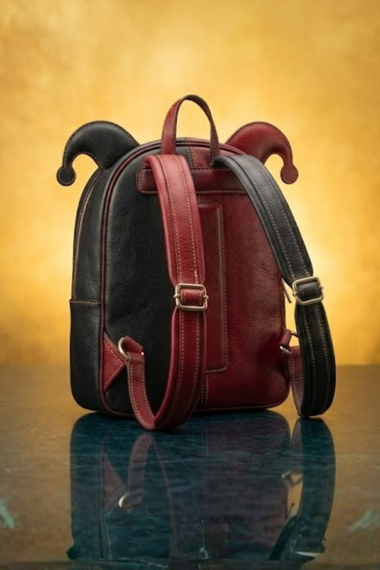 Back view of Harley Quinn inspired leather backpack showing black and red dual-tone exterior with jester horn ears, padded adjustable shoulder straps and gold hardware