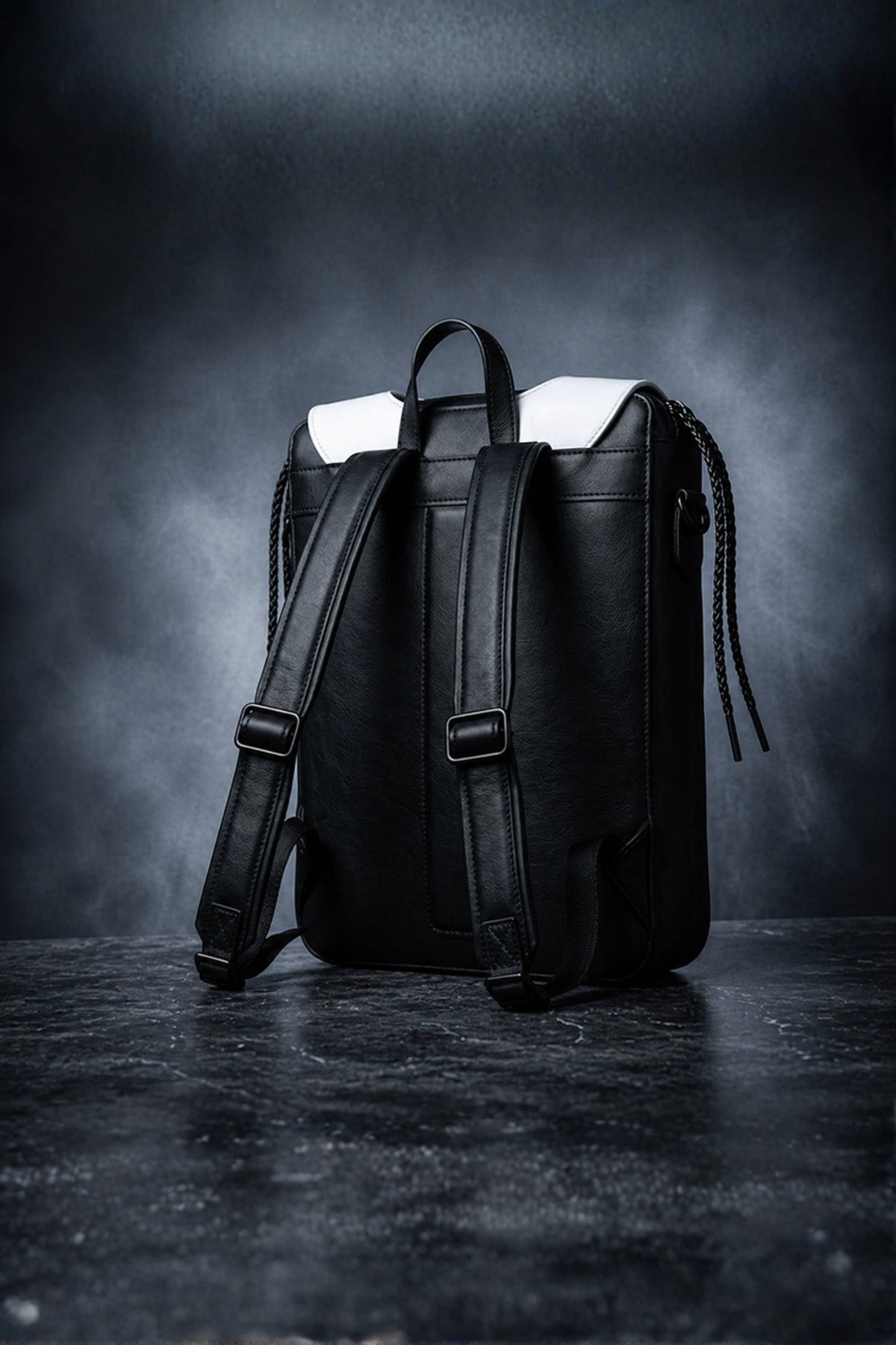 Wednesday inspired genuine leather backpack back view showing smooth jet black body, adjustable padded shoulder straps with matte black hardware and white collar detail visible at top